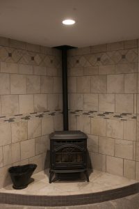 Basement Finish in Wichita, KS Pellet stove with custom tile surround