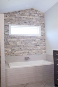 master bath tub with stacked stone accent wall in Wichita, KS