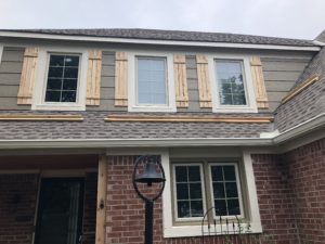 new siding and cedar shutters